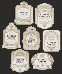 Vector set of ornate labels on the black background in vintage style. Collection of hand-drawn labels decorated by ribbons, crowns, curls in figured frames with place for text and logo