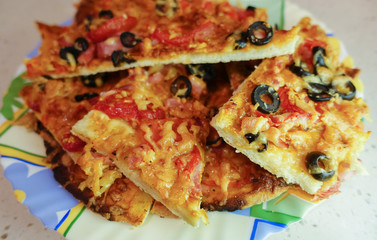 Delicious homemade homemade pizza. Sliced on a plate