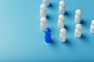 The leader in blue leads a group of white employees to victory, HR, Staff recruitment. The concept of leadership.