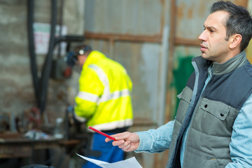 businessman giving directions at warehouse