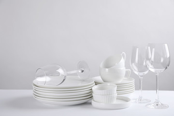 Set of clean dishes on white table