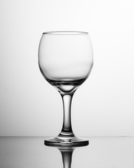 Empty wine glass black and white. Photo of a single round glass wine glass.