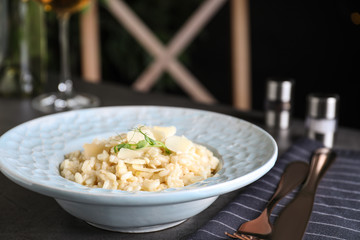 Delicious risotto with cheese on grey table, closeup