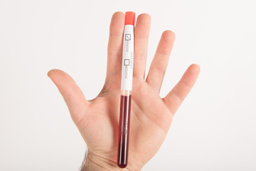 Illustration of hand with gloves holding test-tube with corona virus ncov blood.