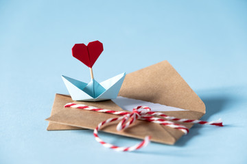 Valentine's day love letter mockup. Craft envelope with white blank card and hearts on blue background. Valentines day, Mothers day, Womens day greeting card.