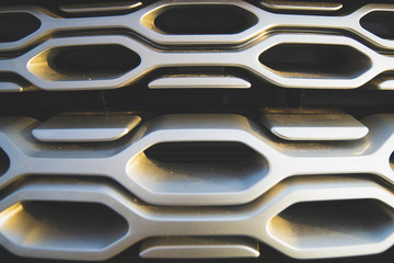 texture.  close-up.  SUV front grille.  silver color