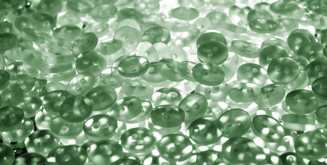green pearl plastic buttons background