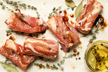 Raw marinated ribs with thyme and peppercorn, flat lay