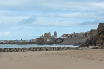 Fototapeta na wymiar Promenade and Cathedral of Santa Cruz in Cadiz, Spain.