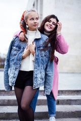 young happy students teenagers at university building on stairs, lifestyle people concept brunette and blond girl