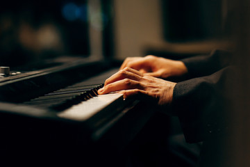 Hands of pianist playing synthesizer close-up © andrew_shots