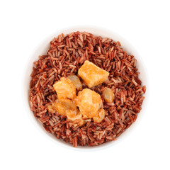 Delicious brown rice in bowl isolated on white, top view