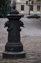 Obraz premium Riga, Latvia. Road pillar with lions heads at Torna street in old town.