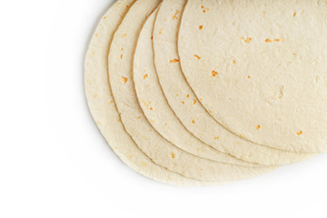 Tortilla on a white isolated background. Corn tortilla or simply tortilla is a type of thin unleavened bread made from Hominy.
