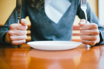 Young woman sitting at table in restaurant