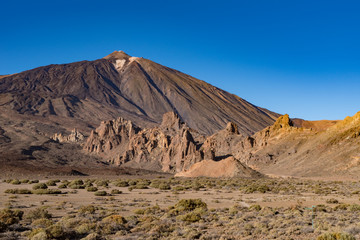  View of Roques de García unique rock formation with famous Pico del Teide mountain volcano summit in the background on a sunset, Teide National Park, Tenerife, Canary Islands, Spain