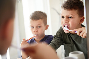 boy brushing teeth dental toothbrush daily habit routine