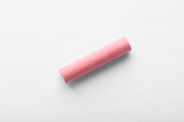 Small piece of pink chalk isolated on white, top view