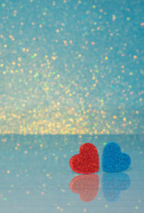 Valentines background. Red and blue Heart on table with reflection on it.  Valentine day love concept. Lovely photo.