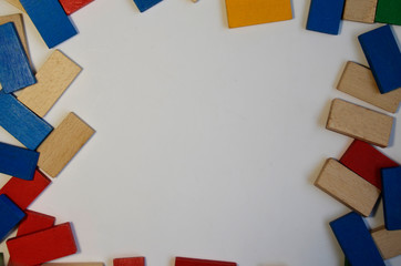 Colored, multi-colored dominoes are scattered on a white background.