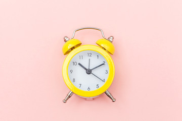 Ringing twin bell vintage classic alarm clock Isolated on pink colourful trendy pastel background....