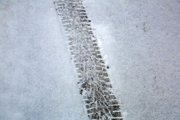 Trace of vehicle tire on a snow-swept surface