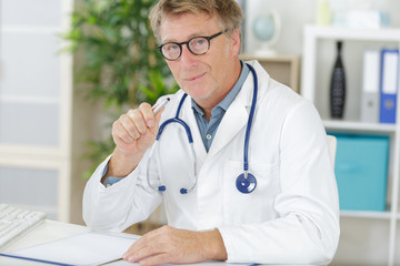 mature doctor looking at camera