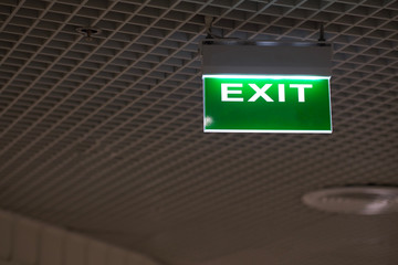 Green light fire exit sign in office building