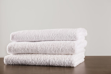 Fototapeta na wymiar Stack of clean bath towels on dark grey table