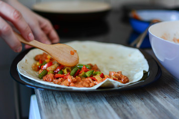 Side view of cooking mexican taco. Cook preparing delicious mexican taco at kitchen. Tasty mexican cuisine. concept cooking recipe.