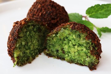 Falafel balls on white background with peppermint leaves for garnish