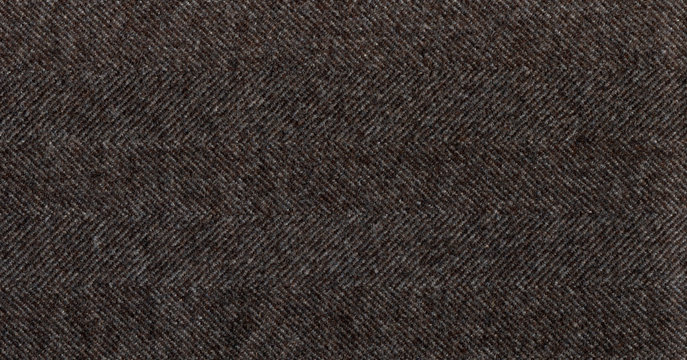 Brown cashmere fabric striped zigzag. Herringbone tweed, Wool Background Texture. Coat close-up. Expensive men's suit fabric. High resolution