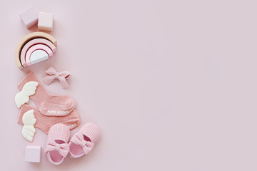 Pink socks, shoes and toys. Set of baby stuff and accessories for girl on pastel background. Baby...