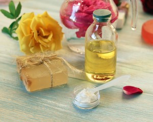 Fresh roses, petals, water and oil on the table for the preparation of natural cosmetics, spa treatments, healthy lifestyle