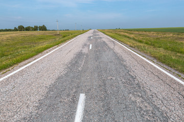 asphalt road goes far into the horizon