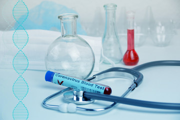 medical laboratory test tube with the word coronavirus test on glass and blood inside, stethoscope,...