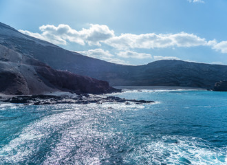 Fototapeta na wymiar The surf on volcanic black beach El Golfo, island Lanzarote