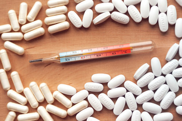 37 degree mercury thermometer with tablets around