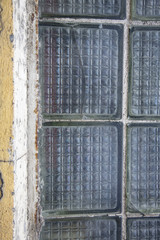 Textured surface of a grunge wall made of squared glass blocks