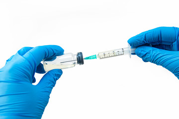 Medical syringe and antibiotic ampoule on a white background in hand