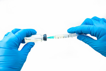 Medical syringe and antibiotic ampoule on a white background in hand