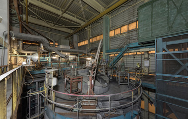 The top of the cylindrical gas treatment reactor with a variety of equipment. Absorption tower inside the waste incinerator plant - obrazy, fototapety, plakaty