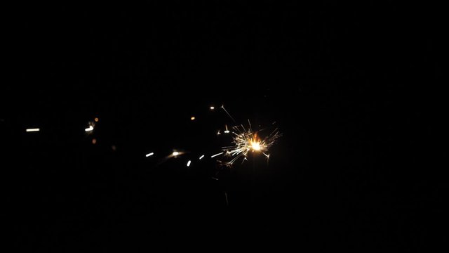 A slow motion bright burning wand of bengali fire against the background of the night