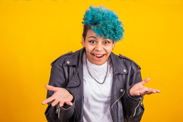 afro american girl with blue curly hair isolated on yellow background