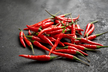pile of Red chili peppers on a black stone