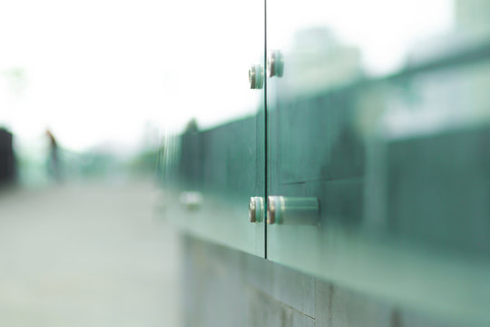 Soft focus, glass fence of a modern city of glass and concrete