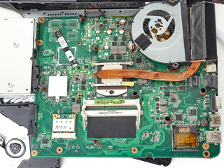A broken laptop that fell on the concrete floor.It lies on a white background with the case open.