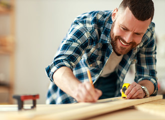 young male carpenter working in  workshop.