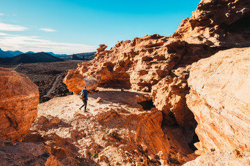 woman walking in the woods and watching rocks