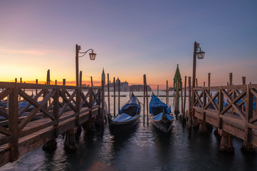 famous gondolas at sunrise. Venice, Italy. picture with long exposure